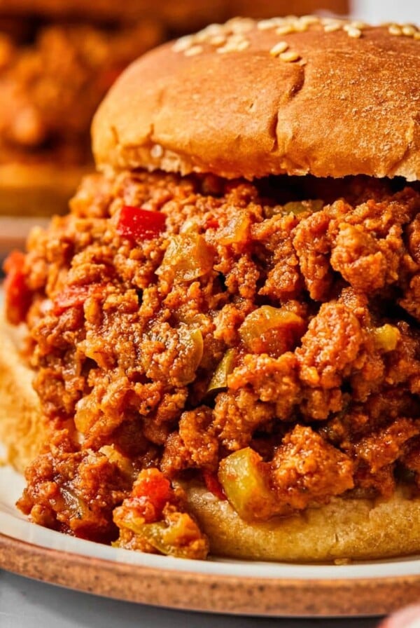 Turkey sloppy joes on buns served on plates on the table.