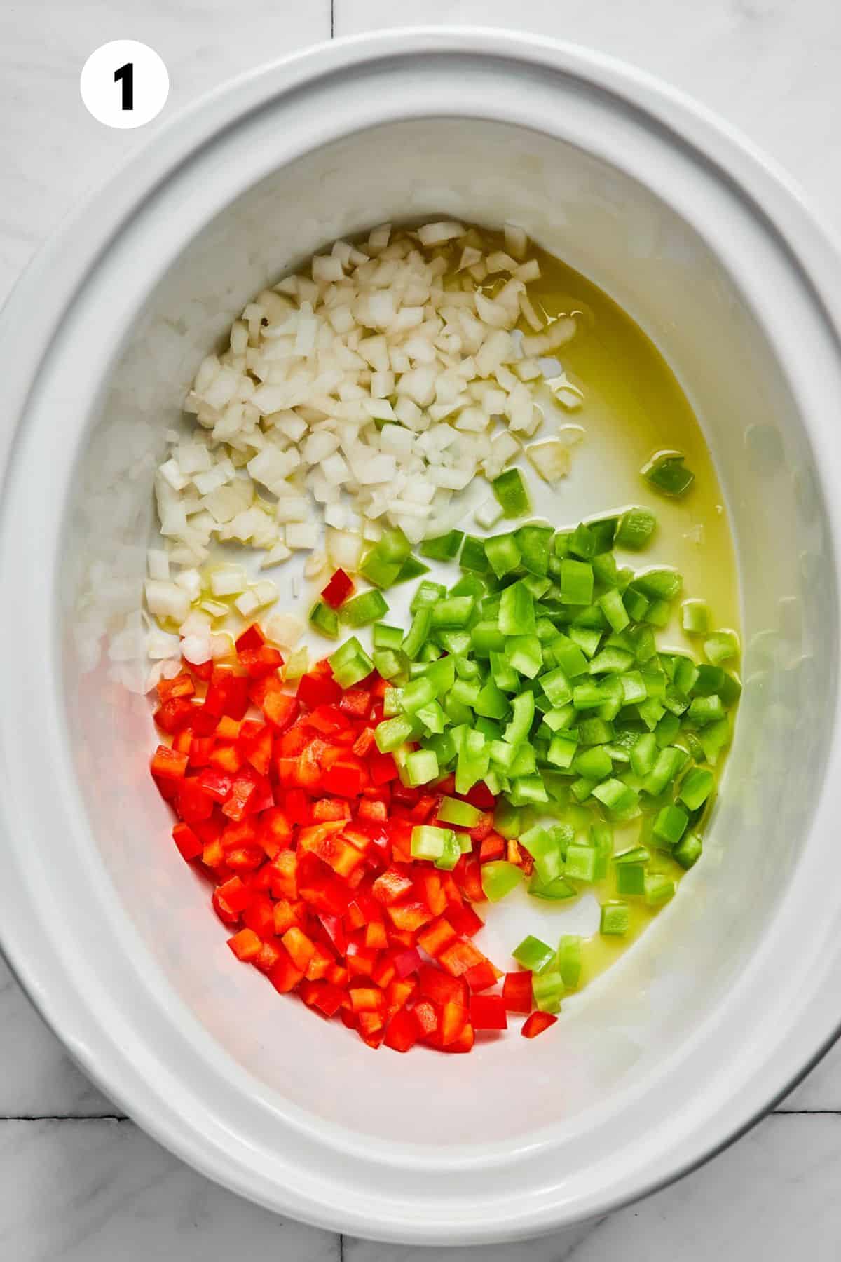 Vegetables and olive oil in the slow cooker.