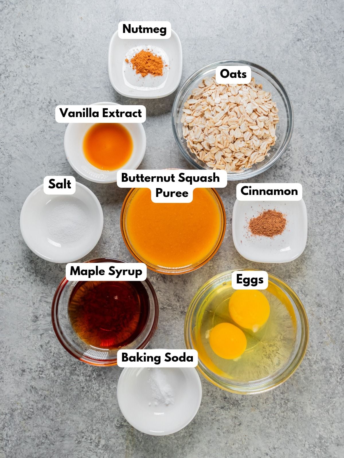 Ingredients to make these butternut pancakes in bowls on a table.