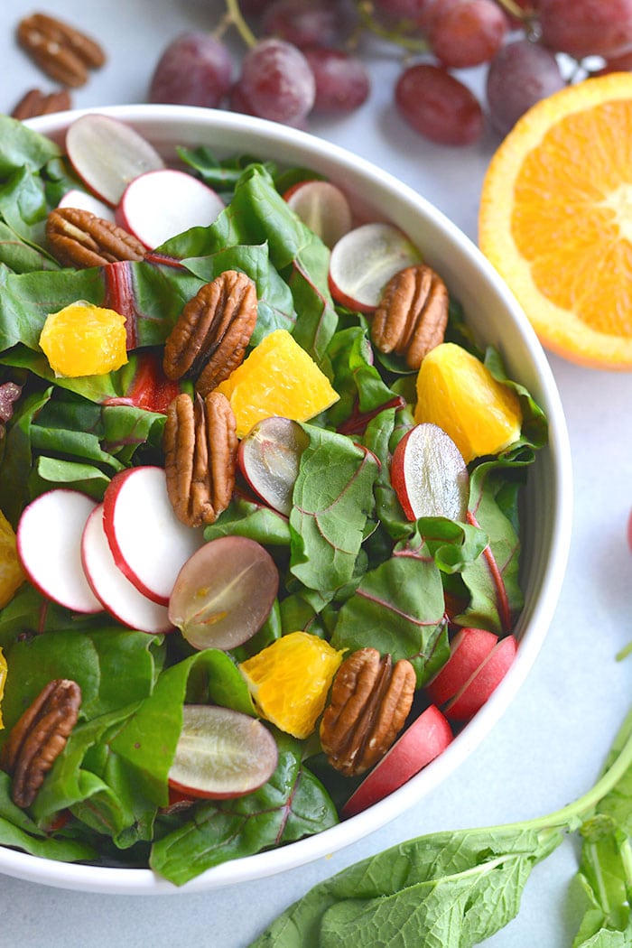 Healthy Holiday Salad! This colorful salad is packed with fresh produce and dressed with an anti-inflammatory turmeric apple cider vinegar dressing. A holiday side salad that's versatile and nutritious! 