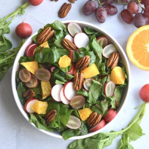 Healthy Holiday Salad! This colorful salad is packed with fresh produce and dressed with an anti-inflammatory turmeric apple cider vinegar dressing. A holiday side salad that's versatile and nutritious!