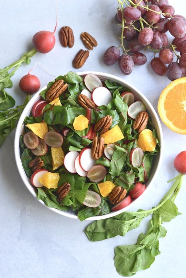 Healthy Holiday Salad! This colorful salad is packed with fresh produce and dressed with an anti-inflammatory turmeric apple cider vinegar dressing. A holiday side salad that's versatile and nutritious!
