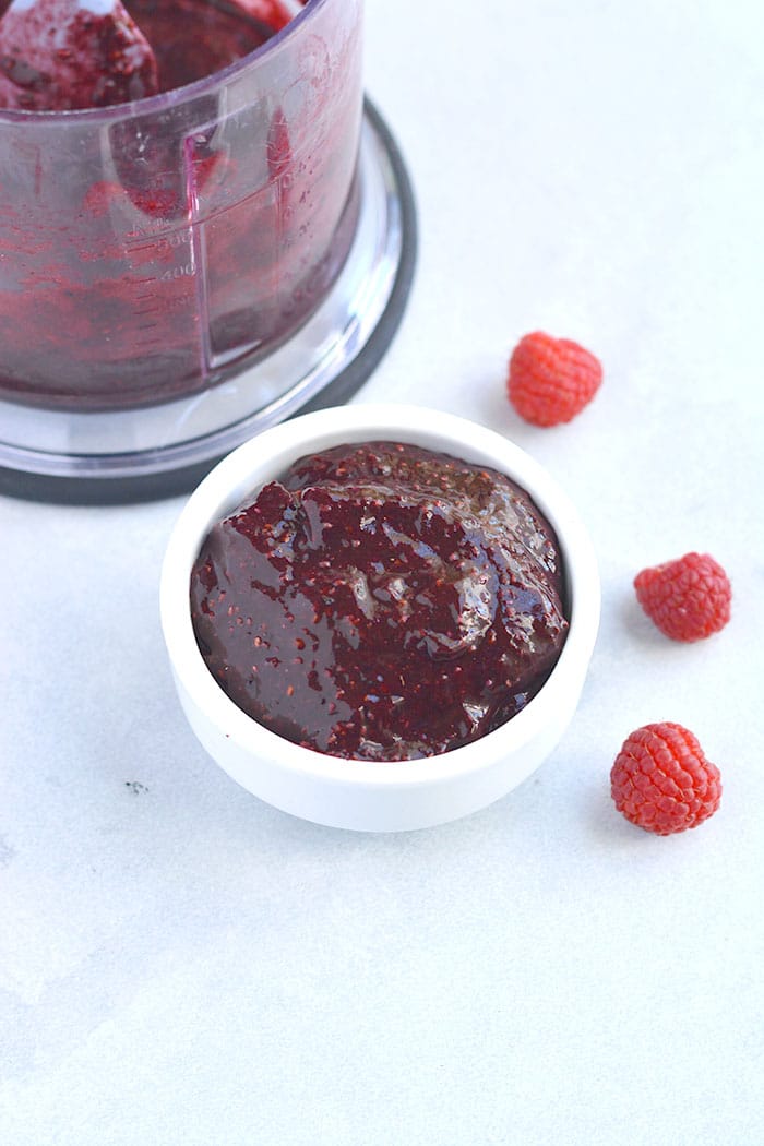 Paleo Raspberry Coconut Thumbprint Cookies! No one will guess these easy to bake coconut and nut butter cookies made with raspberry chia jam are grain free! 