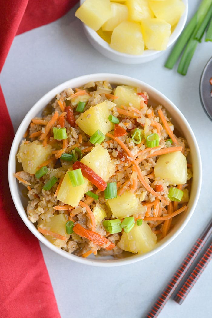 Pineapple Chicken Cauliflower Fried Rice! A simple to make meal packed with delicious flavors the whole family will love. Whole30 compliant, Paleo and incredibly filling! Whole30, Paleo, Gluten Free
