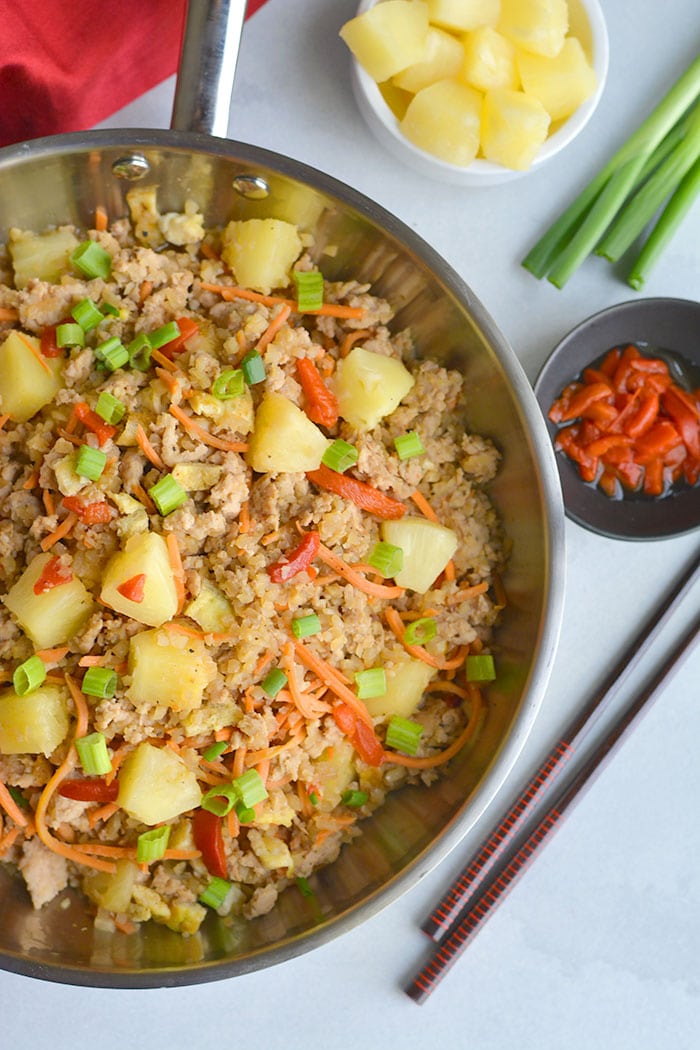 Pineapple Chicken Cauliflower Fried Rice! A simple to make meal packed with delicious flavors the whole family will love. Whole30 compliant, Paleo and incredibly filling! Whole30, Paleo, Gluten Free