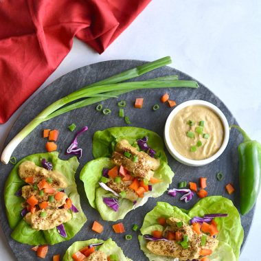 Healthy Thai Peanut Chicken Lettuce Wraps! Chili baked chicken served in lettuce wraps with a peanut buttter sauce. A light dinner or lunch that's easy! Gluten Free + Low Calorie + Low Carb
