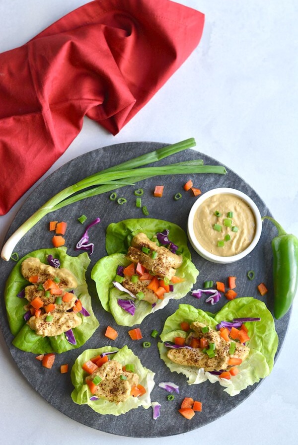 Healthy Thai Peanut Chicken Lettuce Wraps! Chili baked chicken served in lettuce wraps with a peanut buttter sauce. A light dinner or lunch that's easy! Gluten Free + Low Calorie + Low Carb