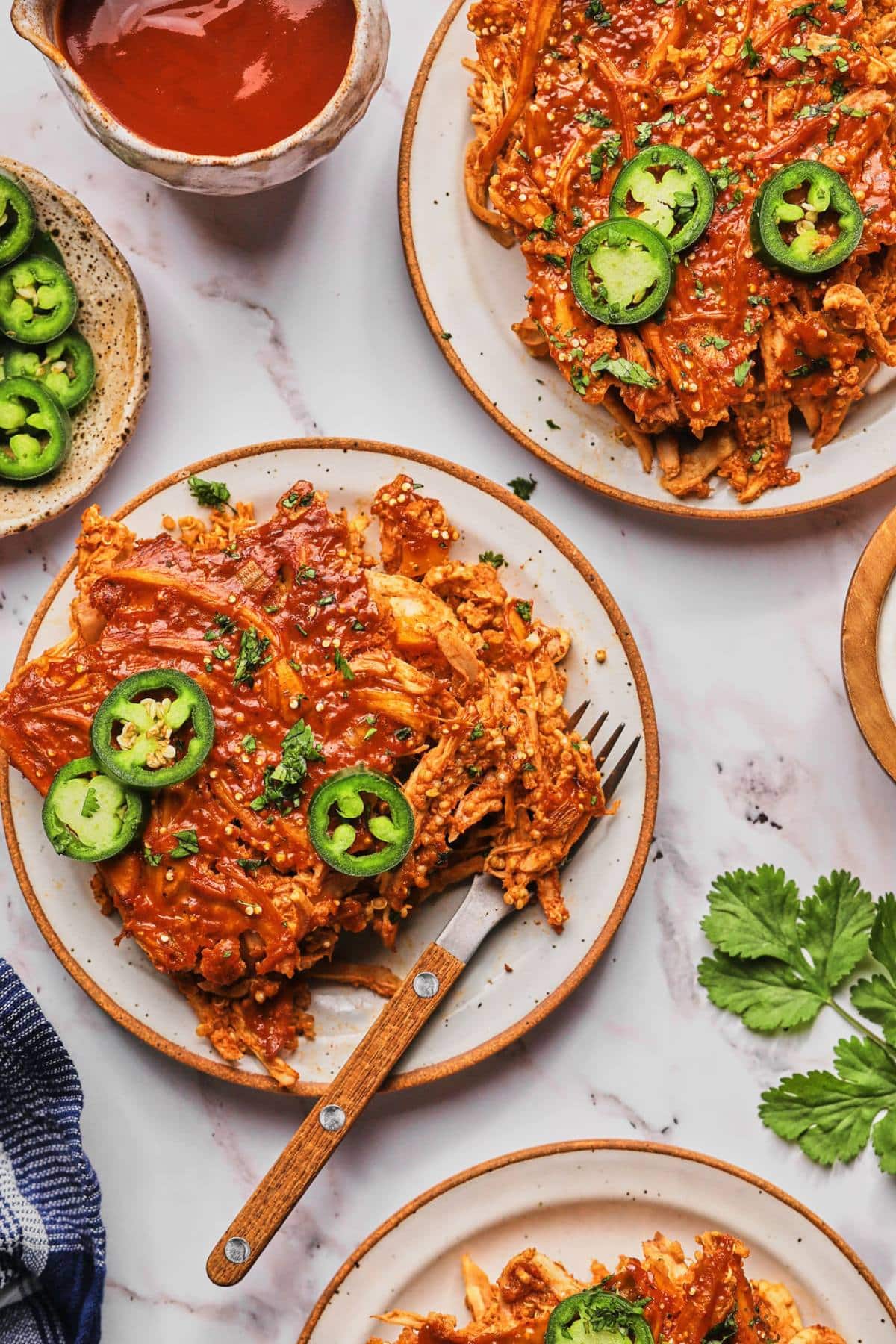 Plates of healthy chicken enchilada casserole on a table.