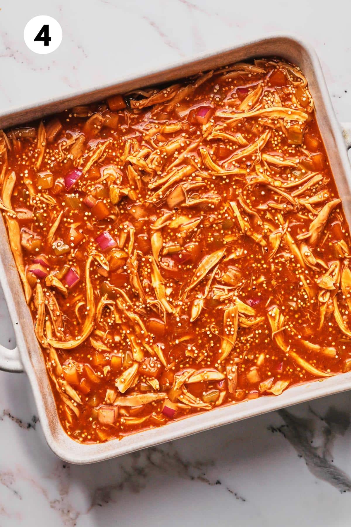 Healthy chicken enchilada casserole mixture poured into a baking dish.