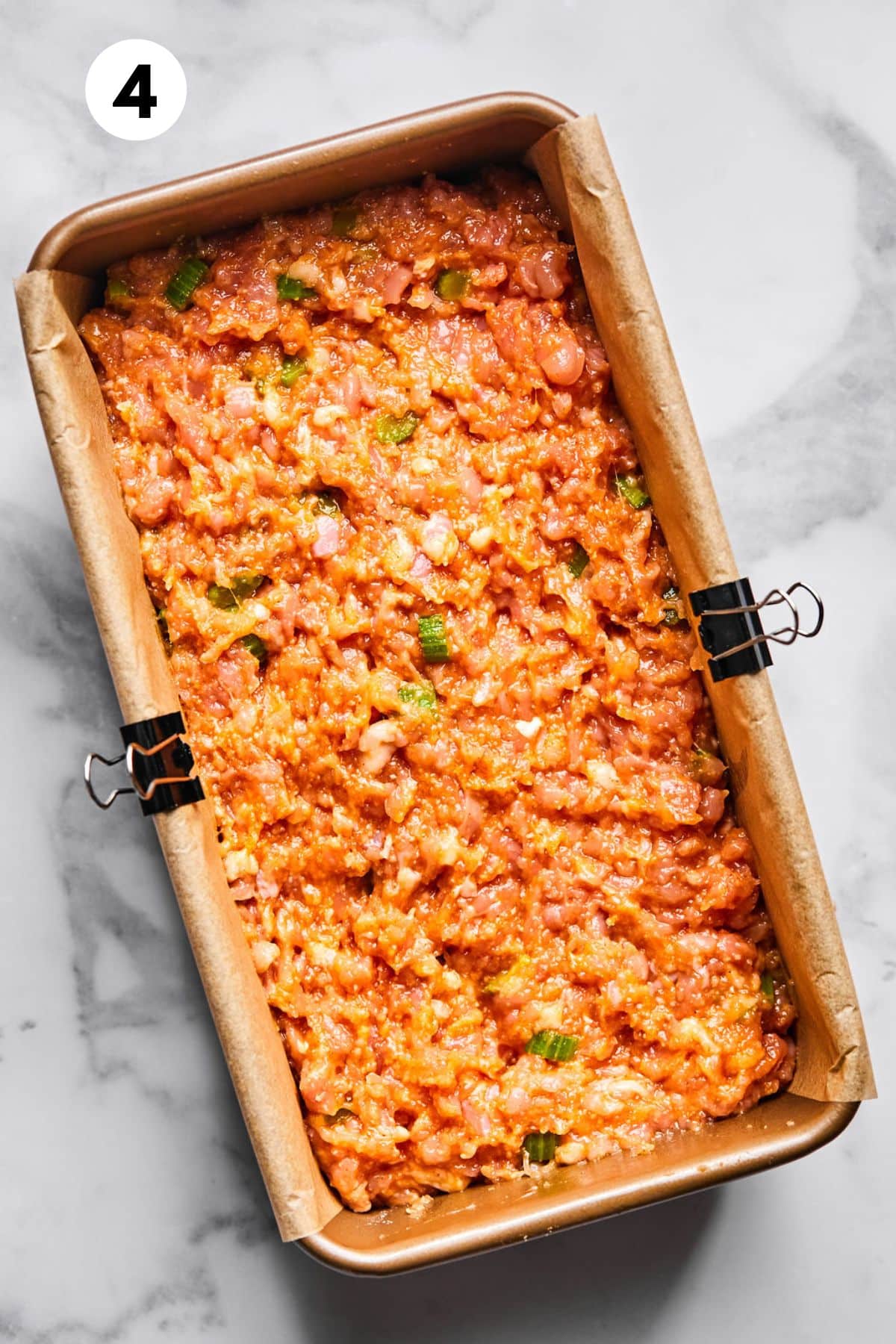 Raw meatloaf in a loaf pan.