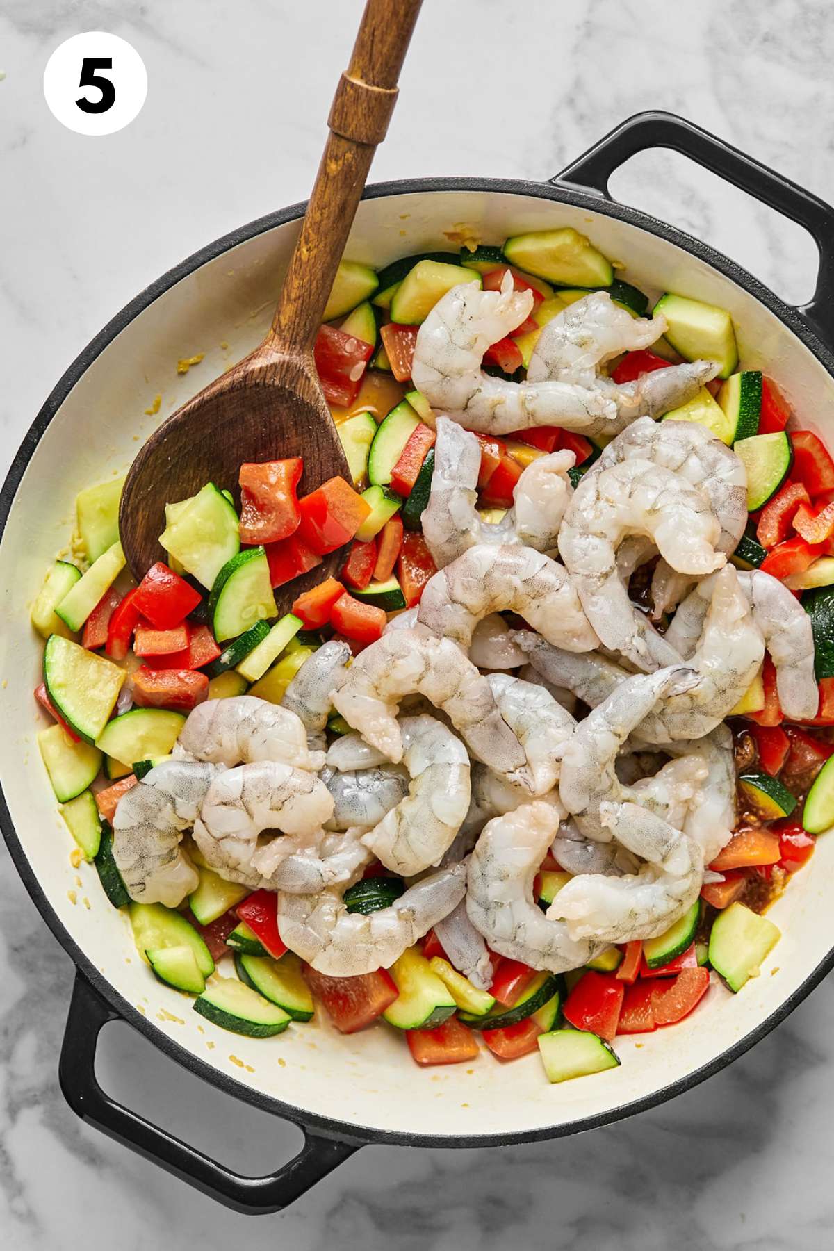 Shrimp added to the skillet of vegetables and sauce.