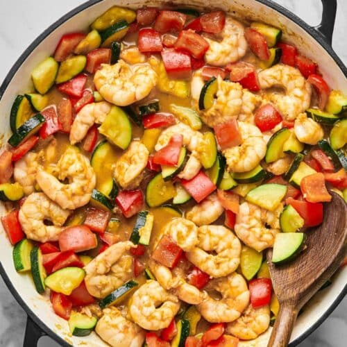 Kung pao shrimp cooked in a skillet.