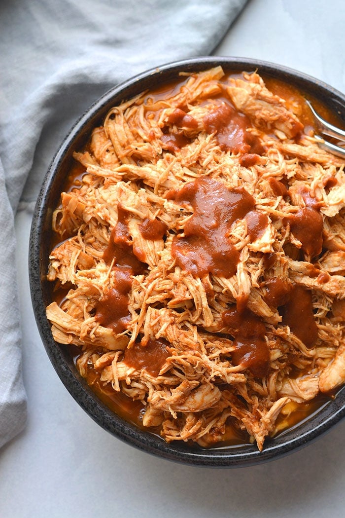 Instant Pot Low Carb BBQ Chicken! Make with a no sugar added BBQ sauce, this Whole30 friendly recipe is quick to make in an Instant Pot in 30 minutes. Toss on a salad, over bread, rice, cauliflower rice or sweet potatoes for an easy meal. Whole30 + Low Carb + Paleo + Gluten Free + Low Calorie