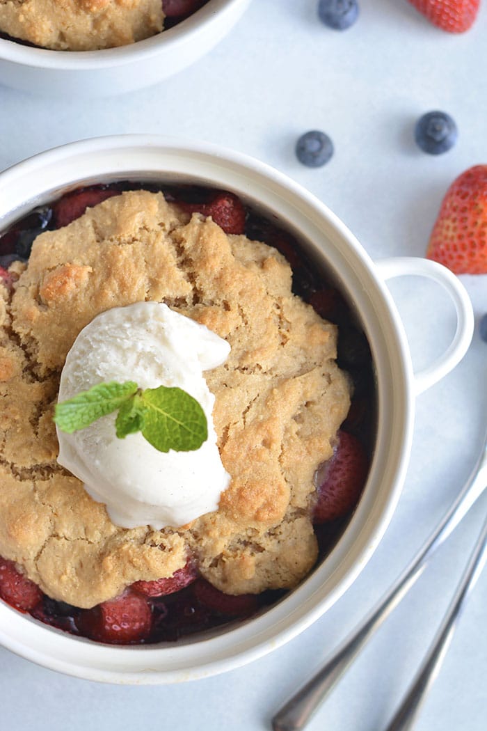 Paleo Berry Cobbler! An irresistible dessert with a delicious almond flour topping! Dairy free, Vegan friendly, easy to make and customize too! 