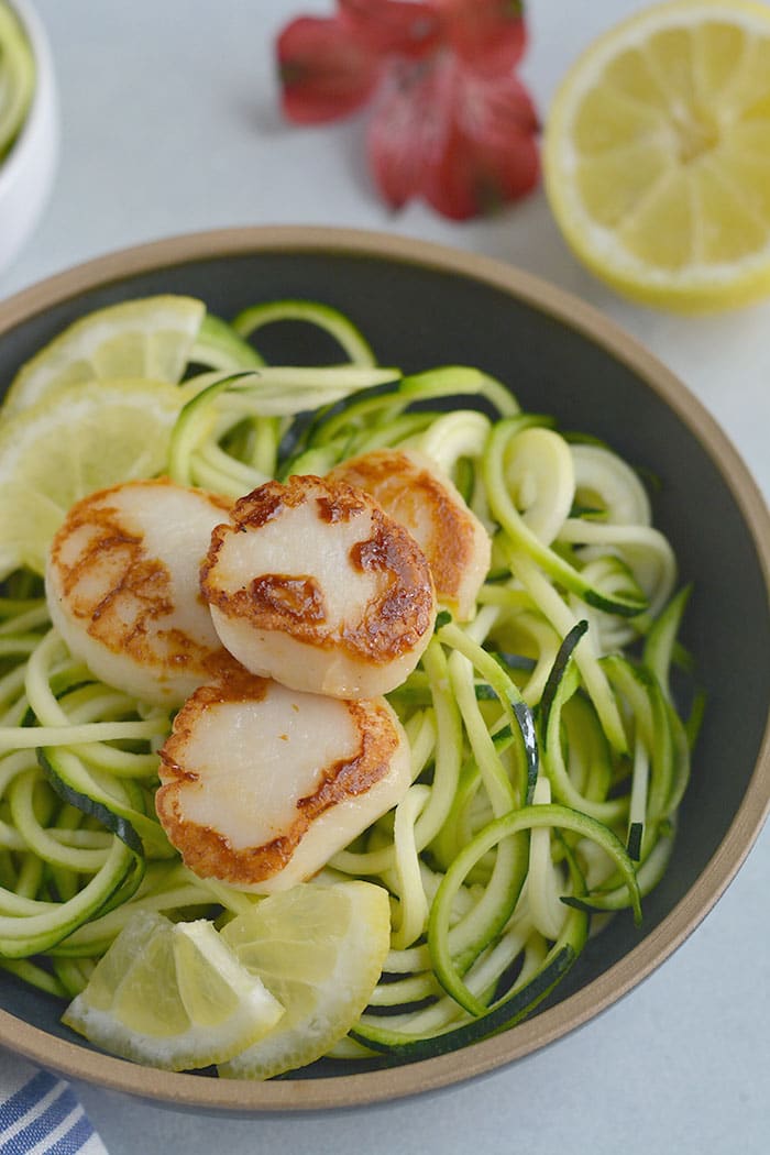 EASY Whole30 Lemon Garlic Scallops Zucchini Noodles with sautéed zucchini noodles. One pan and 10 minutes is what you need for this healthy, low carb meal. Paleo + Whole30 + Low Carb + Low Calorie + Gluten Free