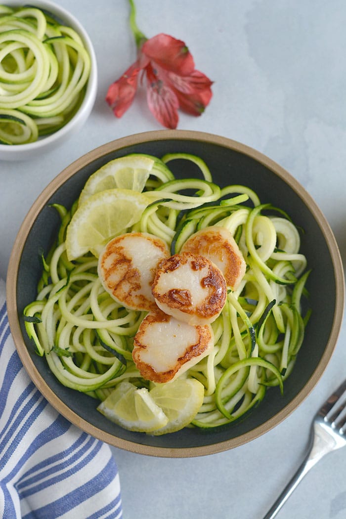 EASY Whole30 Lemon Garlic Scallops Zucchini Noodles with sautéed zucchini noodles. One pan and 10 minutes is what you need for this healthy, low carb meal. Paleo + Whole30 + Low Carb + Low Calorie + Gluten Free
