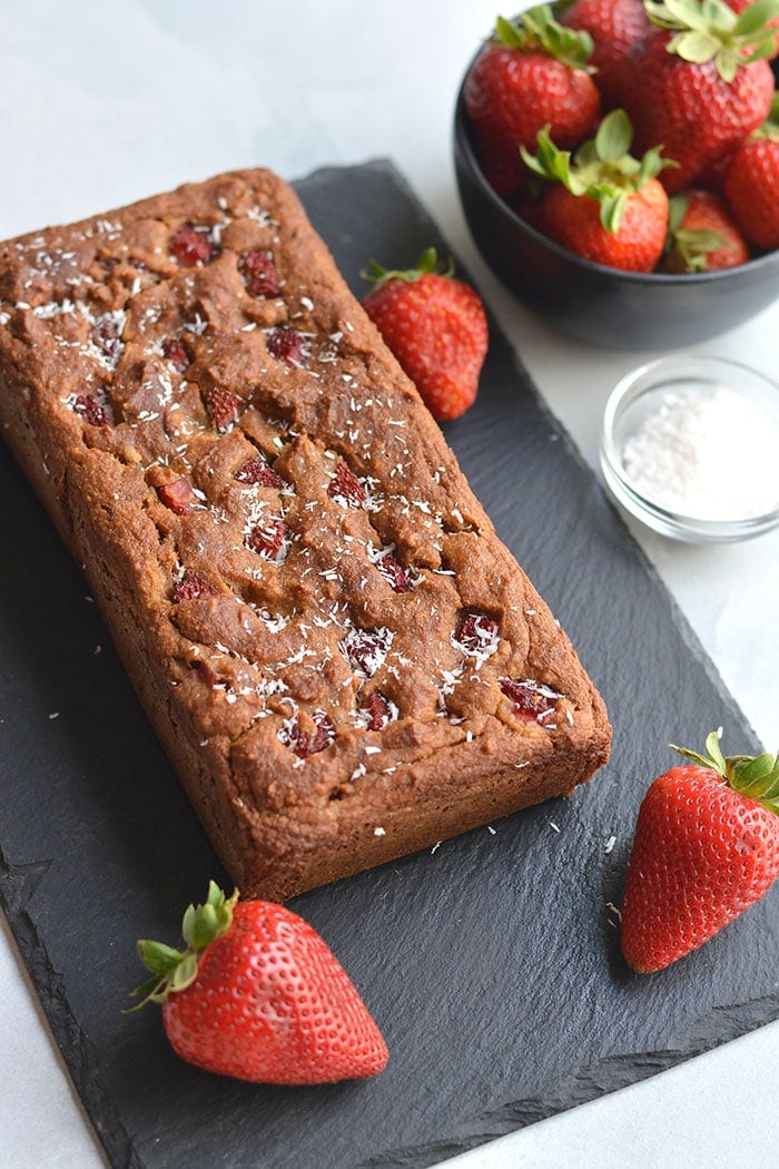 Gluten Free Strawberry Banana Bread! Made with Greek yogurt, packed with fresh berries and naturally sweetened with bananas and coconut flakes. The perfect bread for summer breakfast or snacks. Gluten Free + Low Calorie 