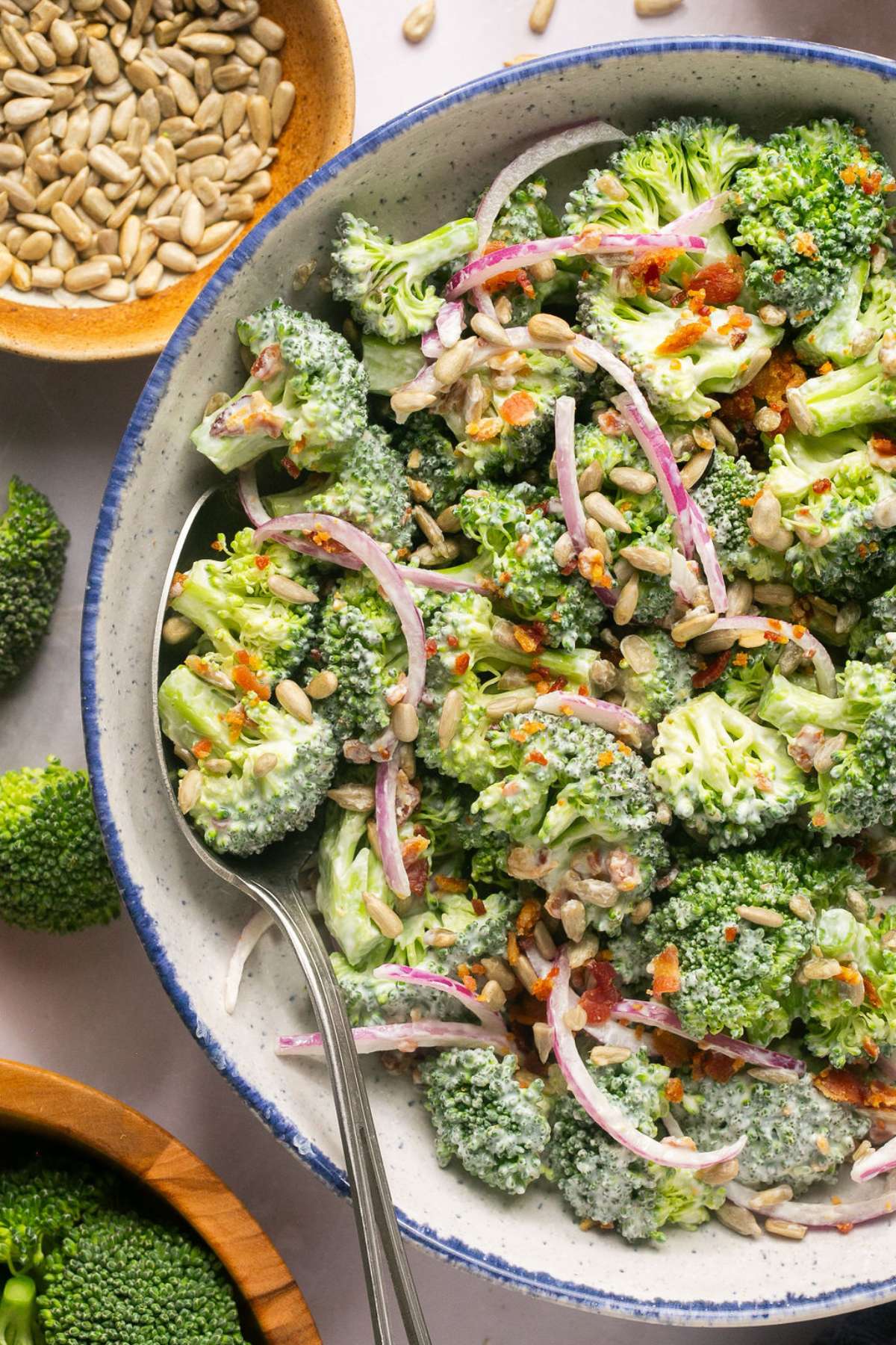 Healthy Greek Yogurt Broccoli Salad! A deliciously sweet salad with crunchy broccoli, bacon and more! No baking required. Just stir, chill and eat. The perfect warm weather salad that's higher in protein and good for you. Gluten Free + Low Calorie