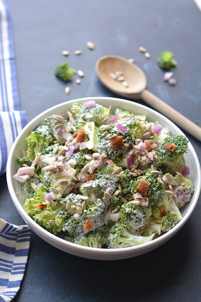Healthy Greek Yogurt Broccoli Salad! A deliciously sweet salad with crunchy broccoli, bacon and more! No baking required. Just stir, chill and eat. The perfect warm weather salad that's higher in protein and good for you. Gluten Free + Low Calorie