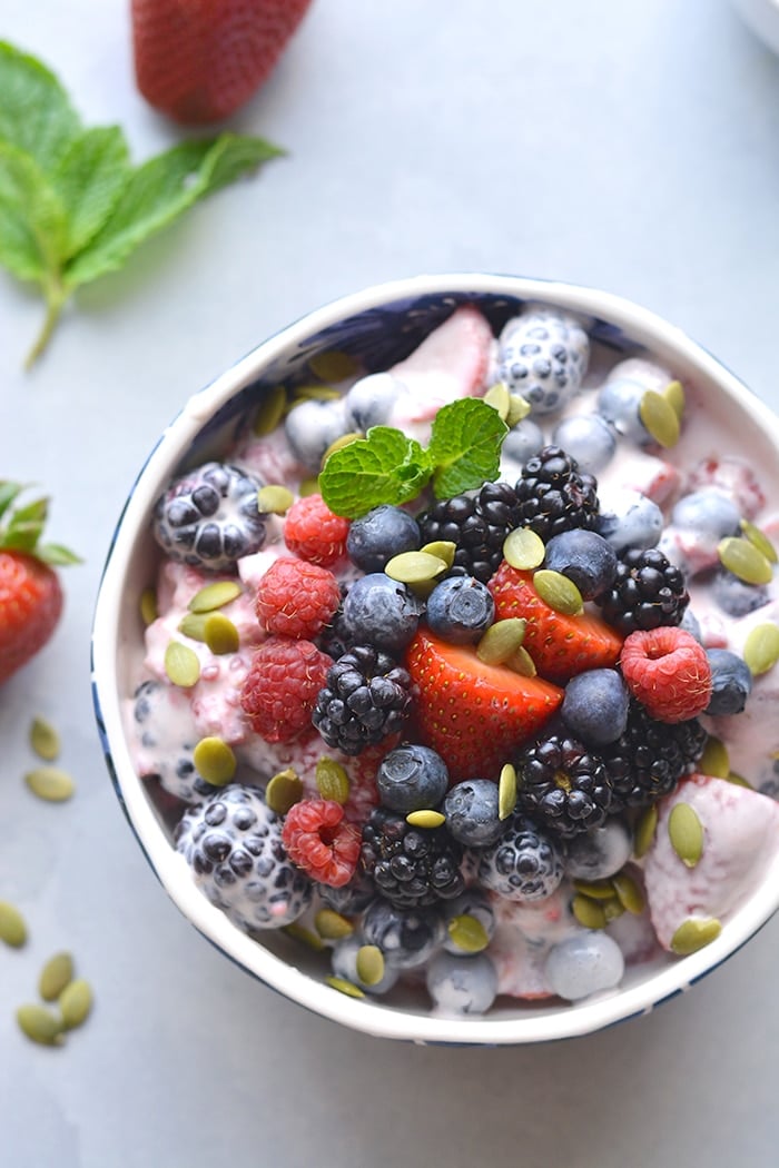 Coconut Greek Yogurt Fruit Salad! Made with fresh fruit, Greek yogurt, vanilla and coconut milk. This salad is a healthier spin on fruit salad. Paleo + Vegan options included. Low Calorie + Gluten Free