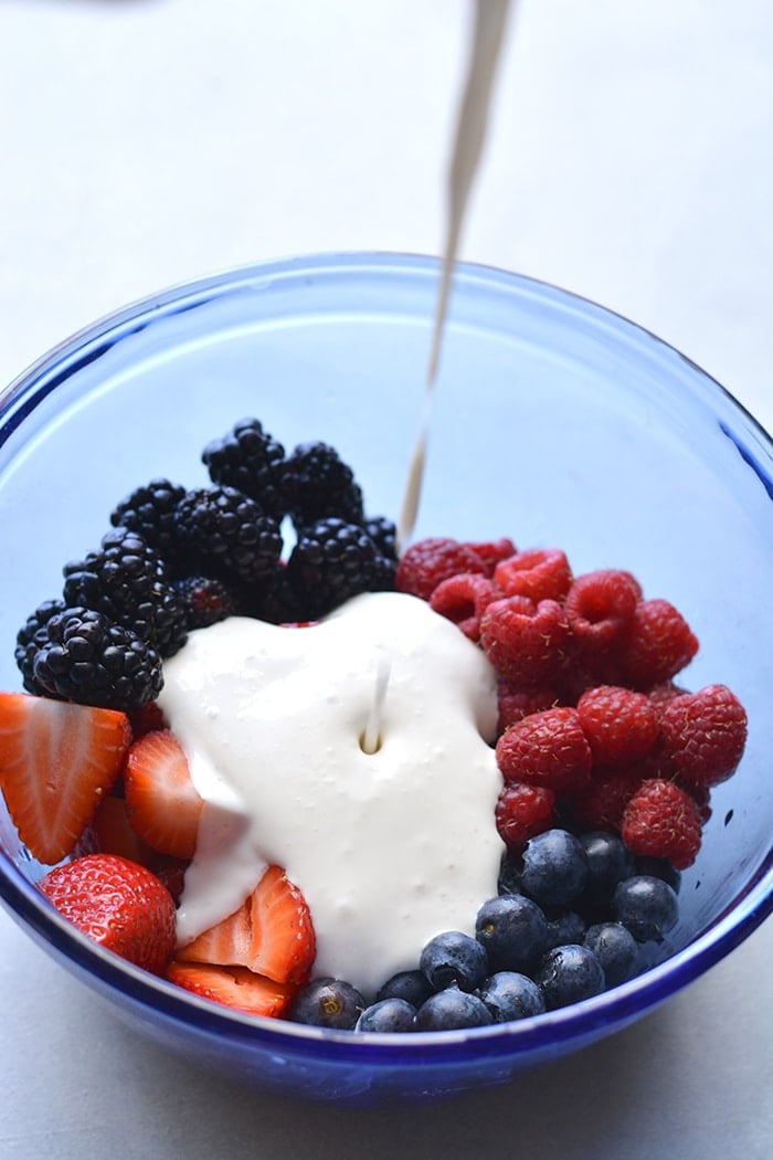 Coconut Greek Yogurt Fruit Salad! Made with fresh fruit, Greek yogurt, vanilla and coconut milk. This salad is a healthier spin on fruit salad. Paleo + Vegan options included. Low Calorie + Gluten Free
