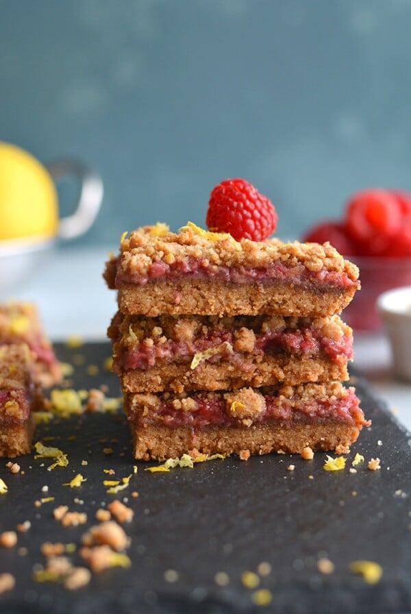 Paleo Vegan Raspberry Crumb Bars! Dairy-free, made with almond flour and wholesome ingredients! A truly addicting grain-free dessert that's good for you. Gluten Free + Low Calorie + Vegan + Paleo