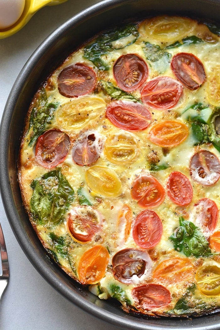 This Tomato Spinach Egg White Frittata is a healthy veggie-filled breakfast. An easy Whole30 recipe that's high protein and great for meal prep! Low Carb + Paleo + Gluten Free + Dairy Free + Whole30 + Low Calorie + Vegetarian