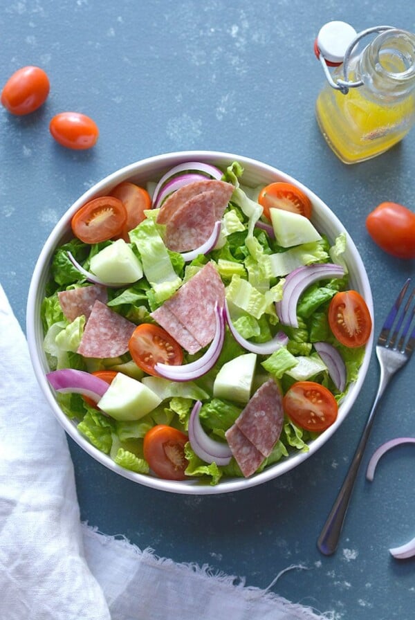 This Low Carb Italian Chopped Salad features crisp summer veggies, salami and a lighter, homemade Italian Dressing. A healthier side salad or summer meal that's mouthwateringly good! Low Carb + Paleo + Gluten Free + Low Calorie