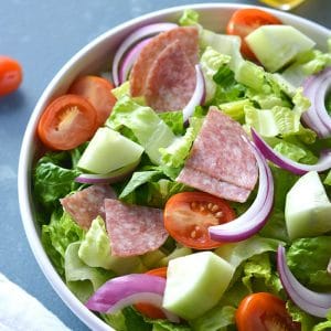 This Low Carb Italian Chopped Salad features crisp summer veggies, salami and a lighter, homemade Italian Dressing. A healthier side salad or summer meal that's mouthwateringly good! Low Carb + Paleo + Gluten Free + Low Calorie