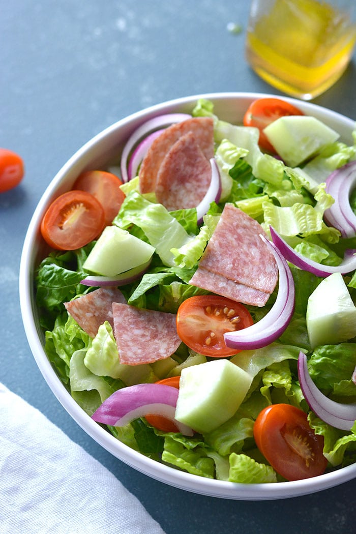 This Low Carb Italian Chopped Salad features crisp summer veggies, salami and a lighter, homemade Italian Dressing. A healthier side salad or summer meal that's mouthwateringly good! Low Carb + Paleo + Gluten Free + Low Calorie