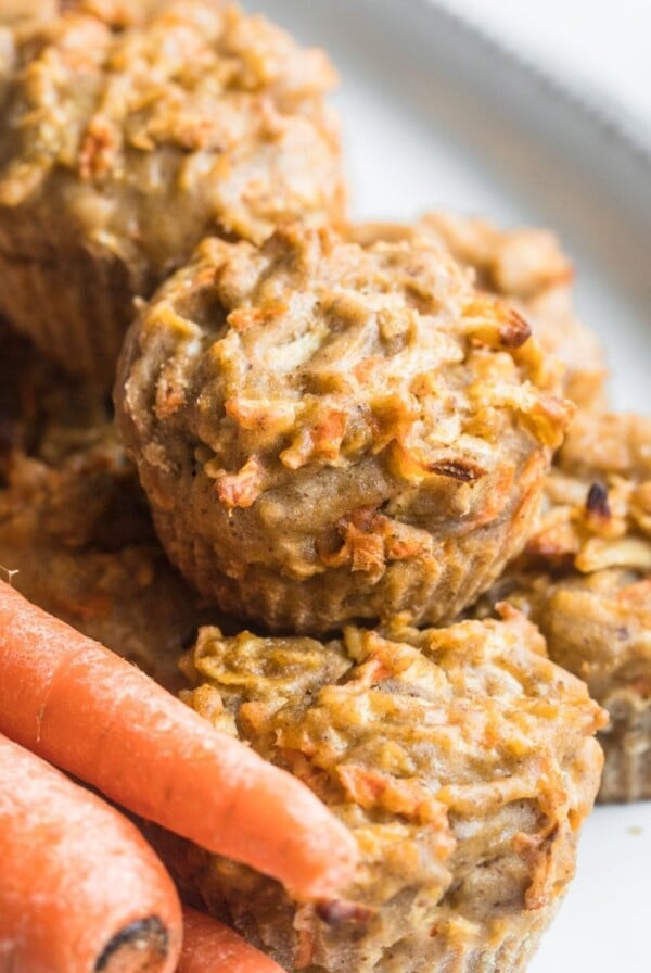 Apple carrot muffins on a plate.