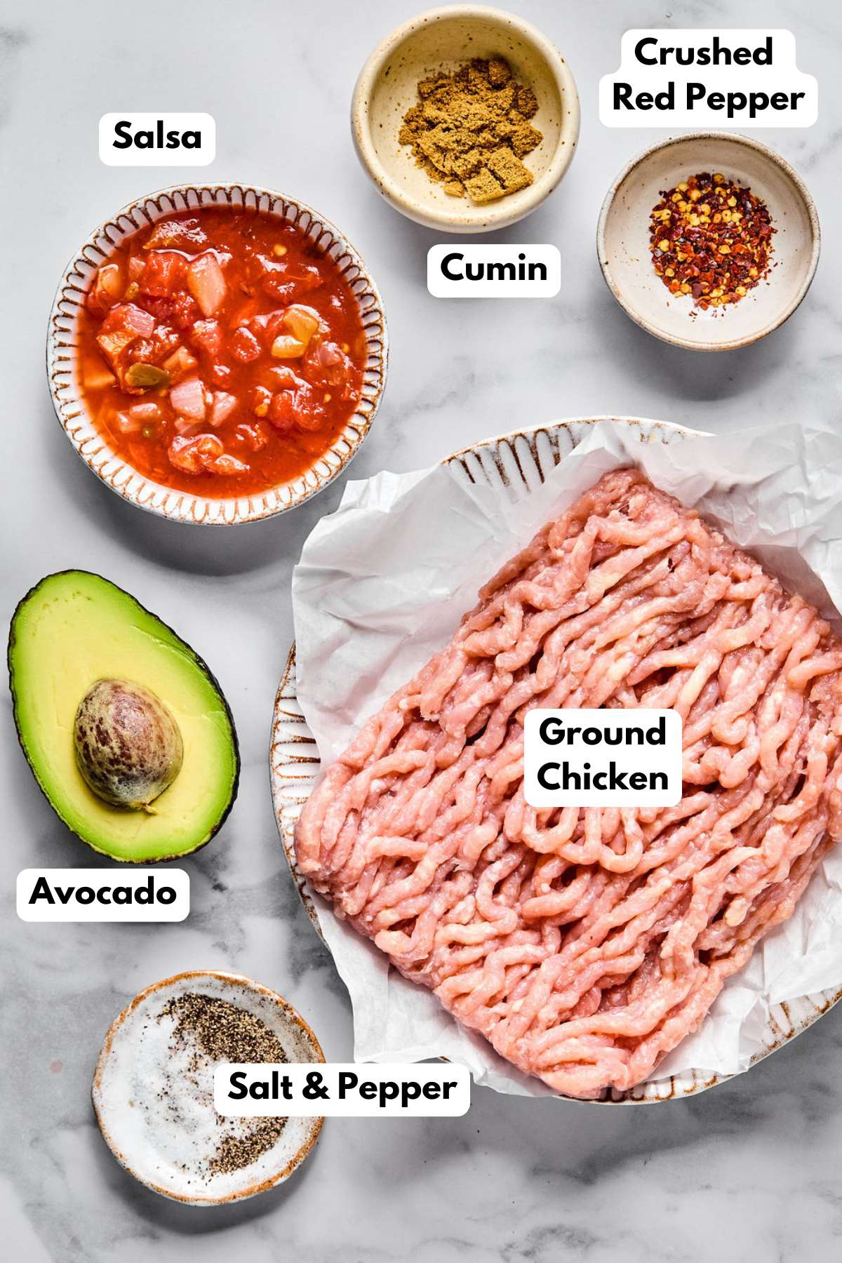 Ingredients to make chicken burgers on a table.