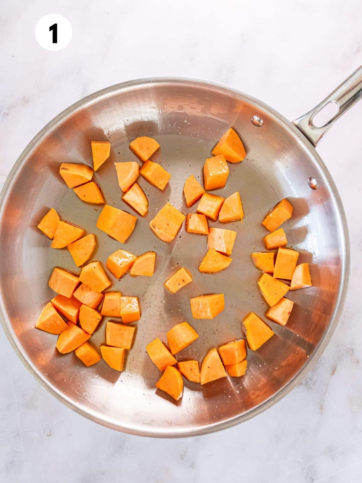 Sweet potato chunks in a skillet.