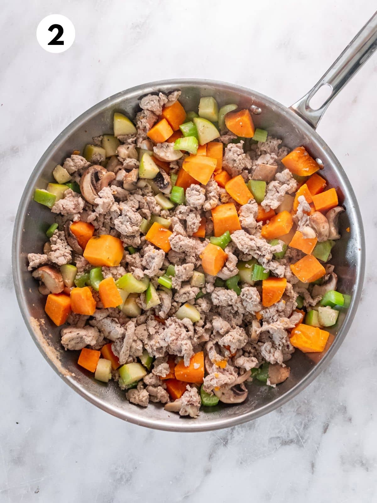 Ground turkey and vegetables in a pan.