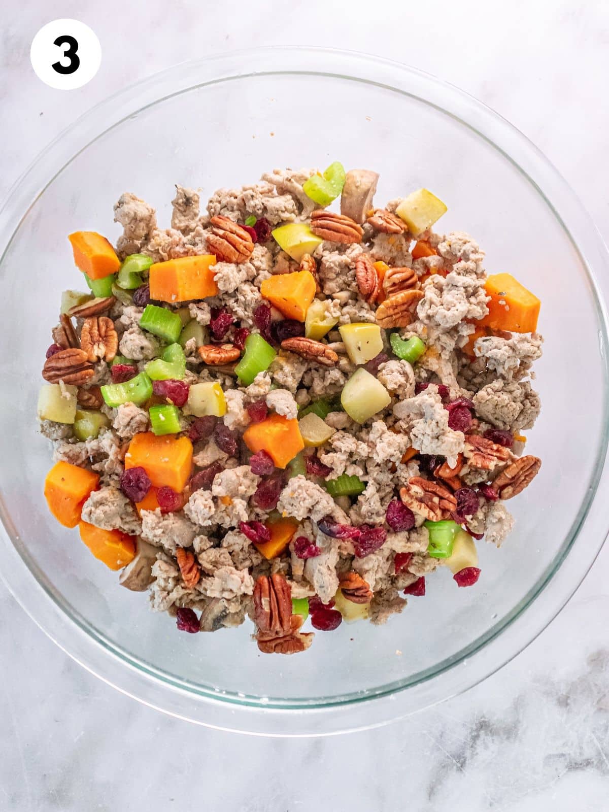 Ingredients for making gluten free stuffing together in a mixing bowl.