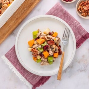 Gluten free stuffing recipe on a plate with a fork resting on the side.