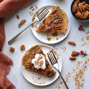 Slices of healthy pecan pie on plates with forks.