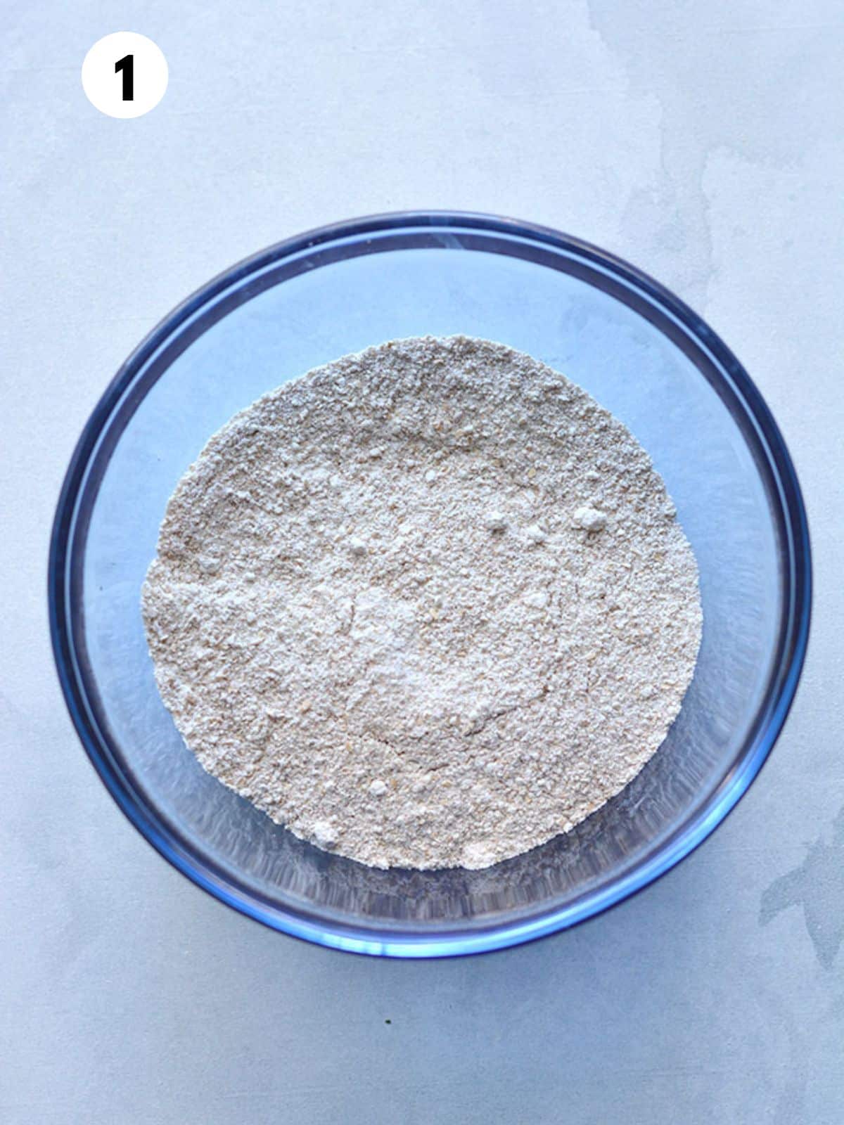 Blended oats in a glass mixing bowl.