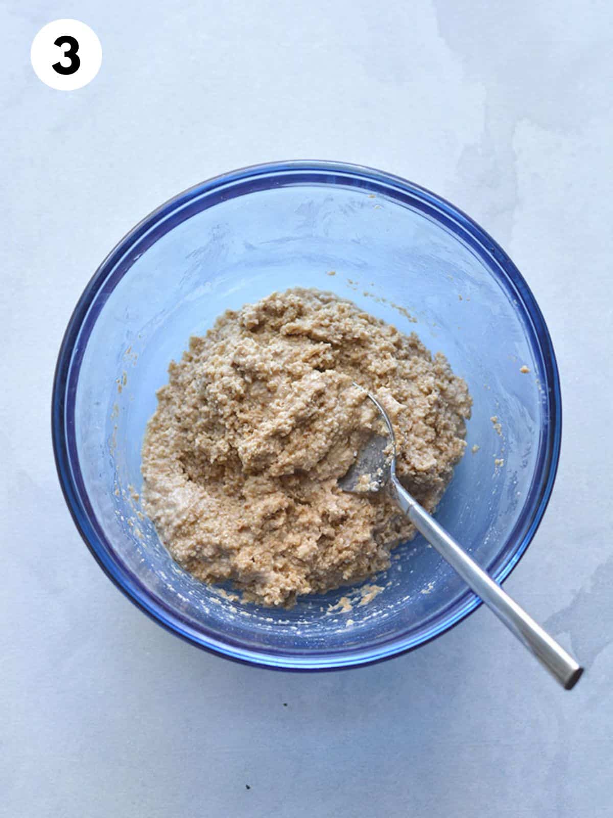 Pie crust ingredients mixed together in a glass bowl.