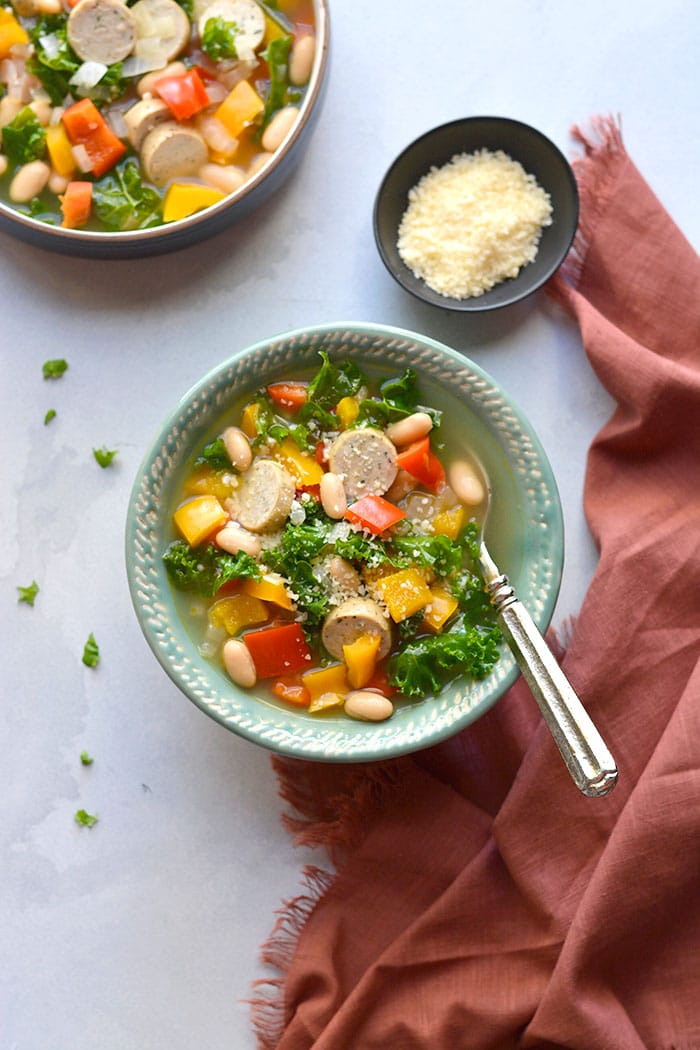 Healthy Kale Sausage Pepper Soup! An easy 30 minute one-pot meal with nourishing vegetables, beans and chicken sausage. High in fiber and protein. Gluten Free + Low Calorie