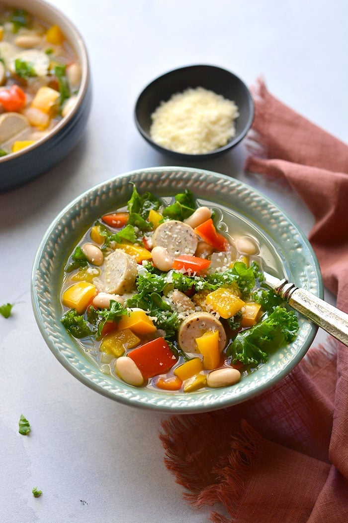 Healthy Kale Sausage Pepper Soup! An easy 30 minute one-pot meal with nourishing vegetables, beans and chicken sausage. High in fiber and protein. Gluten Free + Low Calorie