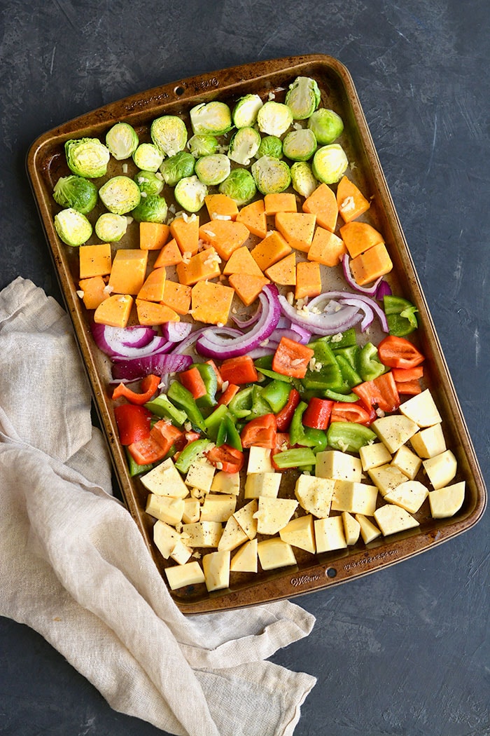 Sheet Pan Sausage and Veggies! Sugar free sausage, Brussels sprouts, butternut squash, sweet potato, red pepper and onion baked together on a sheet pan. A quick, healthy and filling 30-minute meal. Paleo + Gluten Free + Low Calorie