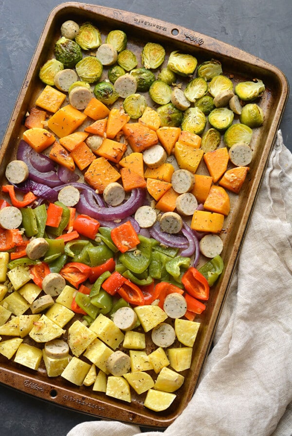 Sheet Pan Sausage and Veggies! Sugar free sausage, Brussels sprouts, butternut squash, sweet potato, red pepper and onion baked together on a sheet pan. A quick, healthy and filling 30-minute meal. Paleo + Gluten Free + Low Calorie