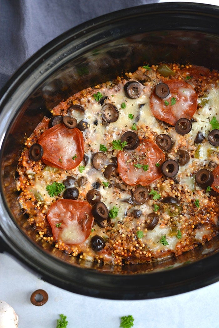 Crockpot Pizza Quinoa! This easy and healthy slow cooker meal is a lighter version of pizza with healthier ingredients. Nourishing, tasty and customizable. Gluten Free + Low Calorie