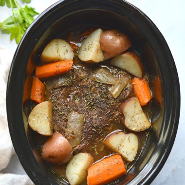 Healthy Crockpot Pot Roast! The BEST slow cooked pot roast you will ever eat. Perfectly tender, juicy and delicious! Served with carrots and potatoes for an easy meal. Gluten Free + Low Calorie
