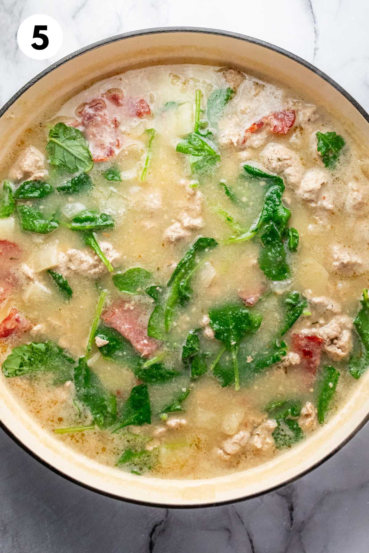 Zuppa toscana soup in a pot after cooking.