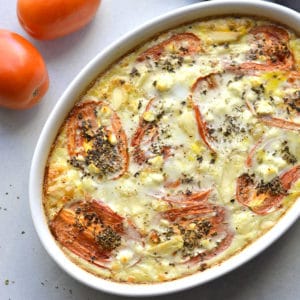 Cheesy Roasted Tomato Egg Bake is a high protein, low carb breakfast filled with roasted tomatoes, garlic, spices and creamy feta. An easy, low calorie egg bake for meal prep! Gluten Free + Low Carb + Low Calorie