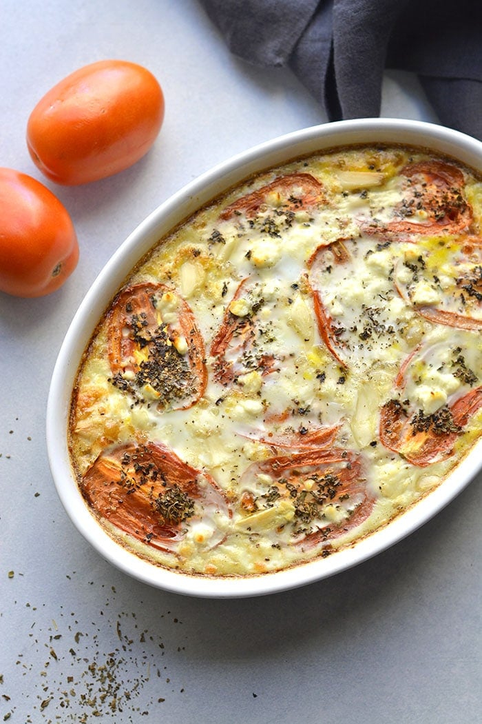 Cheesy Roasted Tomato Egg Bake is a high protein, low carb breakfast filled with roasted tomatoes, garlic, spices and creamy feta. An easy, low calorie egg bake for meal prep! Gluten Free + Low Carb + Low Calorie