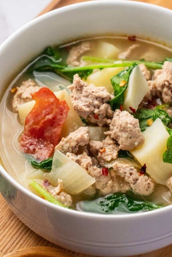 A bowl of healthy zuppa toscana on the table ready to eat.