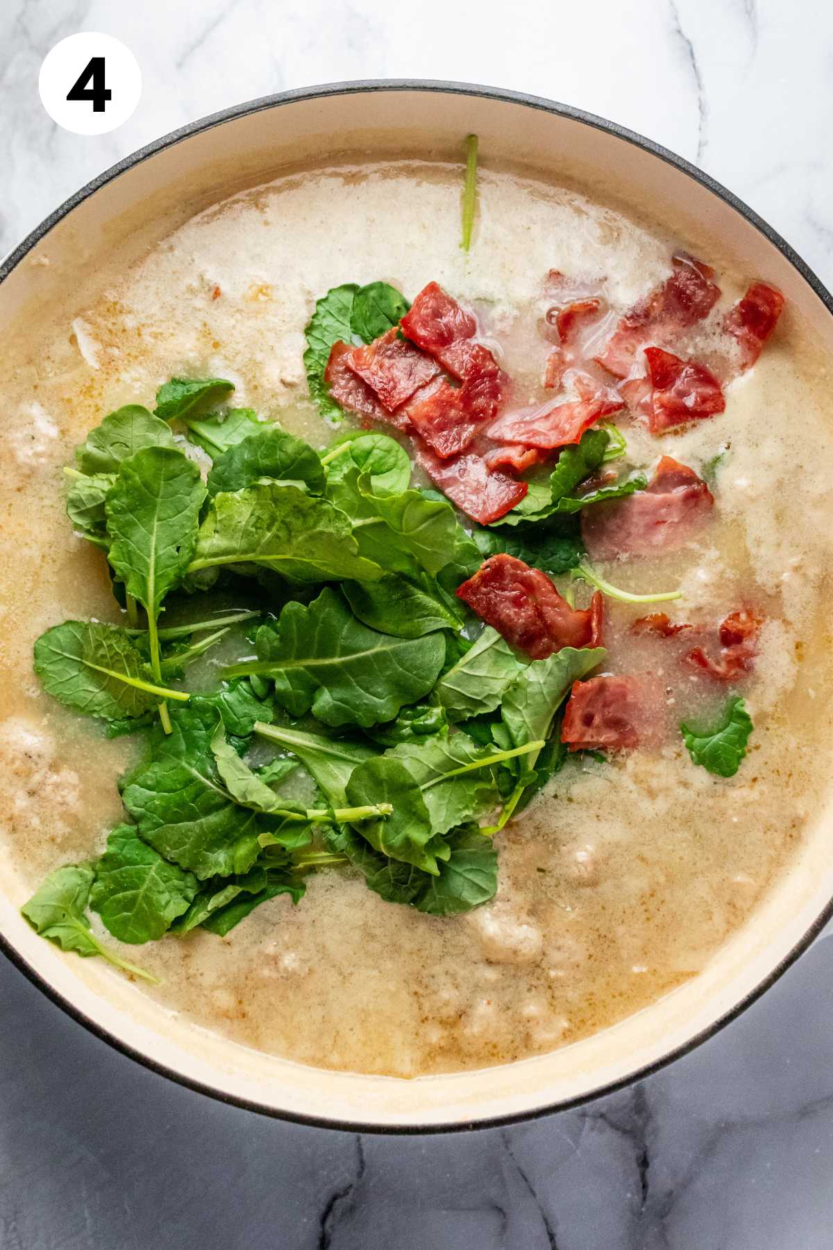 Spinach and cooked bacon added to the pot of soup.